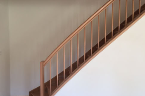 FHG am Hörnli, Holztreppe mit Geländer vor einer weißen Wand.